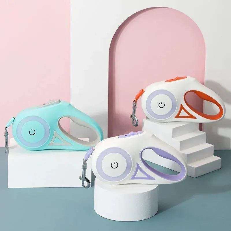 Three colorful electronic devices on stands with a pastel pink and blue background