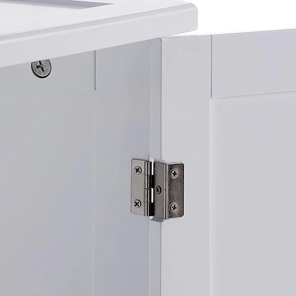 Close-up of a metallic hinge on a white cabinet door
